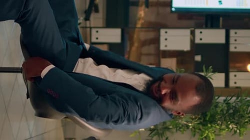 Businessman Smiles and Celebrates a Success in Office