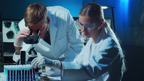 Scientist and Student Working in Lab Doctor Teaching Intern to Make Blood Analyzing Research