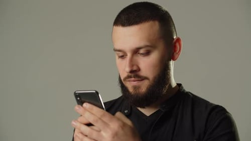 Man Uses Smartphone on Clean Background