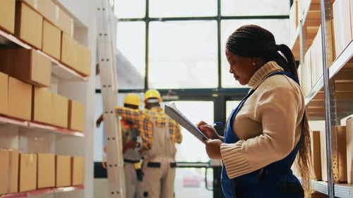 Warehouse Manager with Clipboard in Box Storage Facility