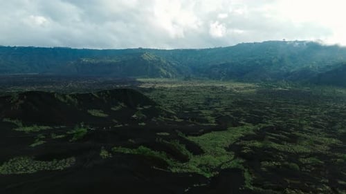 Aerial Drone View Flying Low Over Solidified Black Volcanic Lava Mount Batur