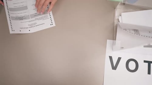 Close Up In the Selection Committee of the Election Company a Guy Registers to Vote a Young Girl