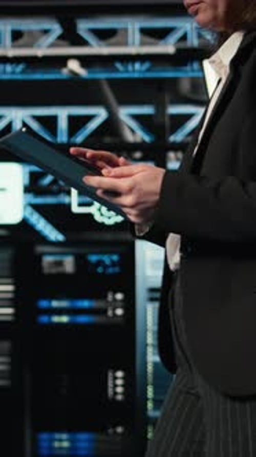 Vertical Video Technician Walking in Data Center Using AR Simulation to Conduct Security Audit