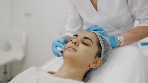 Woman receiving facial cleaning treatment in a spa