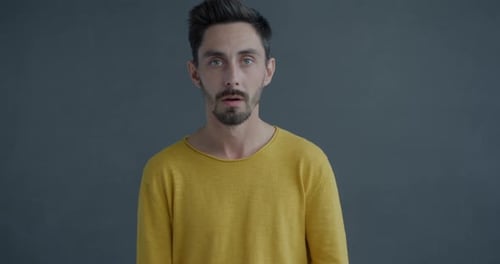 Man Reacts with Shock and Surprise in Studio