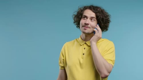 Smiling Positive Man Talking By Phone Smiling Curly Haired Guy on Blue Studio