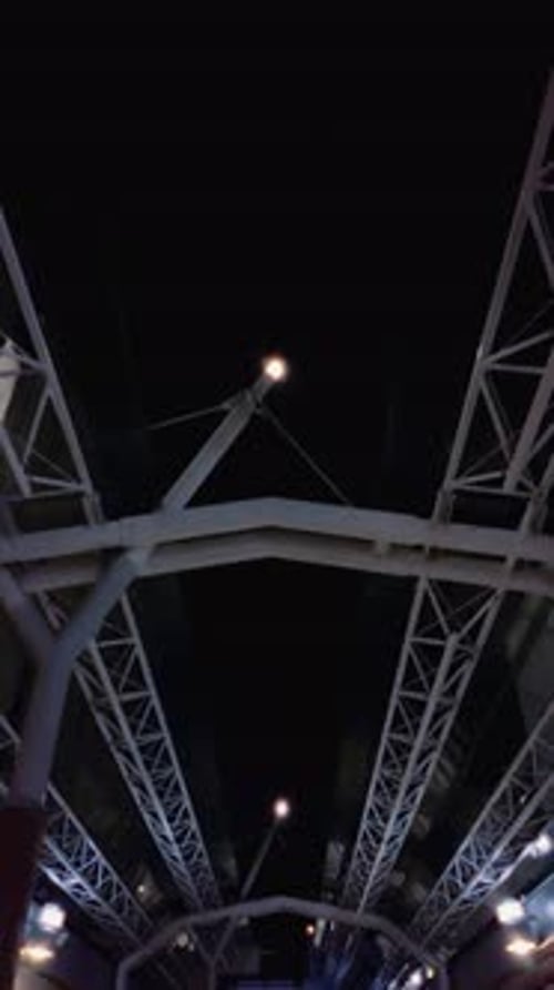 Steel Canopy Framework with Streetlights at Night in Amsterdam Noord