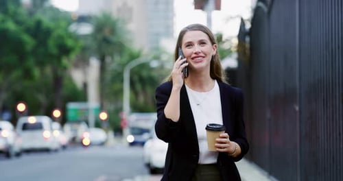 4k video footage of a well dressed corporate businesswoman making a phonecall while in the city