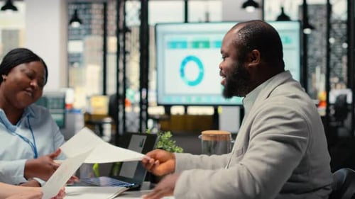 Recruiting Team and an Applicant Engaging in CV Evaluation in a Business Office