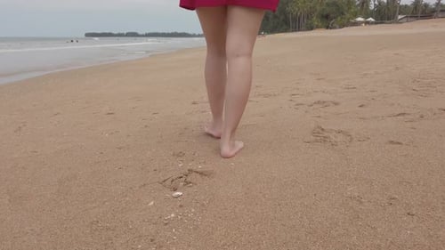 View to bare foot walking on the beach at summer vacation holidays, closeup of legs and feet on whit