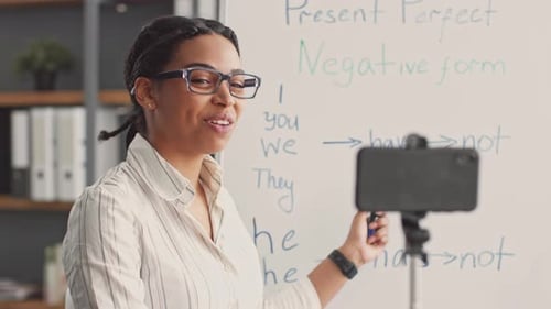 Smiling Teacher Explains Grammar During Online Lesson