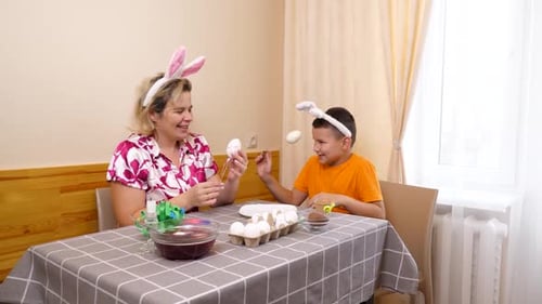 34 1. Mother and son celebrate Easter. They prepare a basket, paint eggs and have fun.
