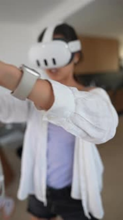 Woman Enjoying Immersive VR Gaming Experience at Home