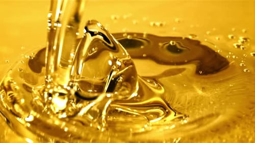 Golden Liquid Pouring and Splashing