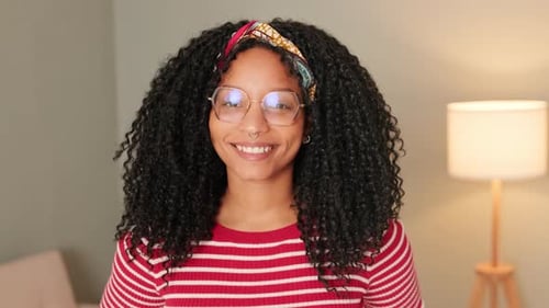 Smiling Woman With Curly Hair and Glasses