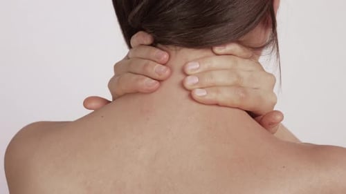 Woman Massaging Her Stiff Neck with Hands