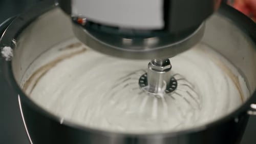 Closeup in a Professional Kitchen a Machine Beats Dough for a Cake Sweet Pastries