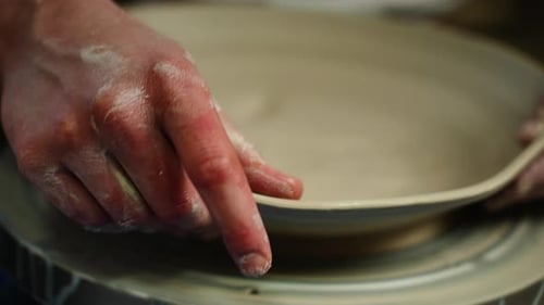 Crop of Unknown Man Artisan in Pottery Workshop Making Clay Pot on Rotary Machine