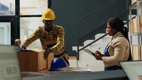 Warehouse Workers Prepare Packages for Shipping