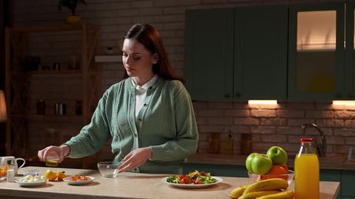 Woman Prepares Salad Dressing in Kitchen