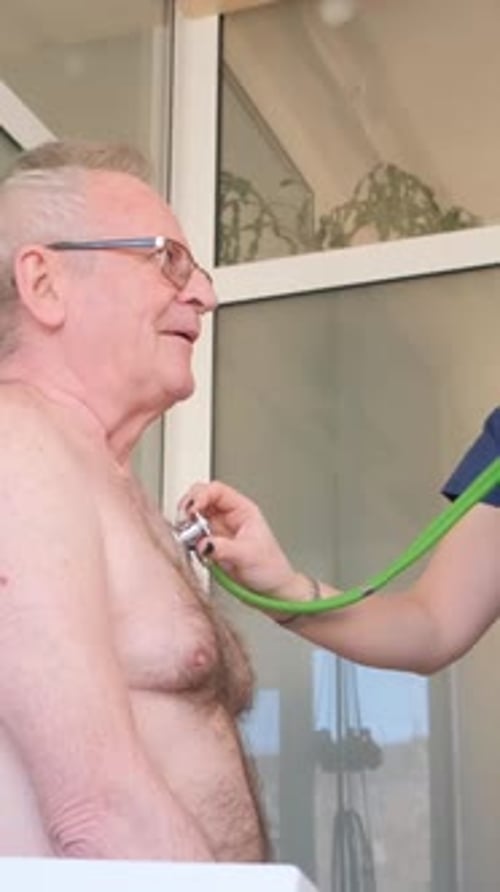 Doctor Listens to Senior Man Heart with Stethoscope