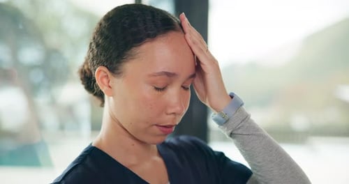 Woman Touches Her Head With Eyes Closed Indoors