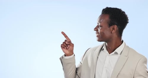 Happy black man, pointing and options in advertising or marketing in studio against a blue