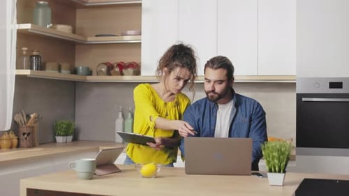 Couple Working Together at Home on Laptop