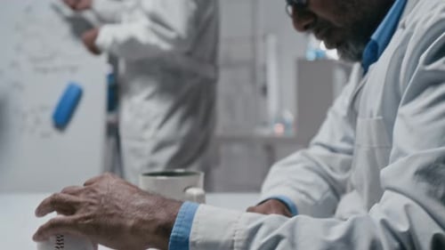 Stressed Scientist in Lab With Colleagues
