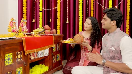Devout Couple Praying at Home Shrine