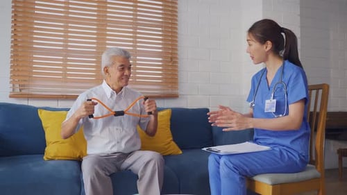 Senior Man Exercising with Therapist in Home