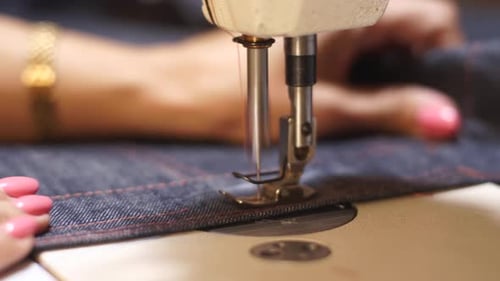 Close Up Macro Shot of Female Hands Working on Sewing Machine Near Presser Foot and Needle Caucasian