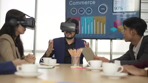 White collar worker are using VR simulator while meeting at office.