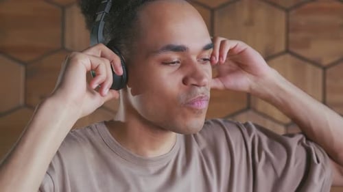 Young Man Enjoys Music with Headphones On