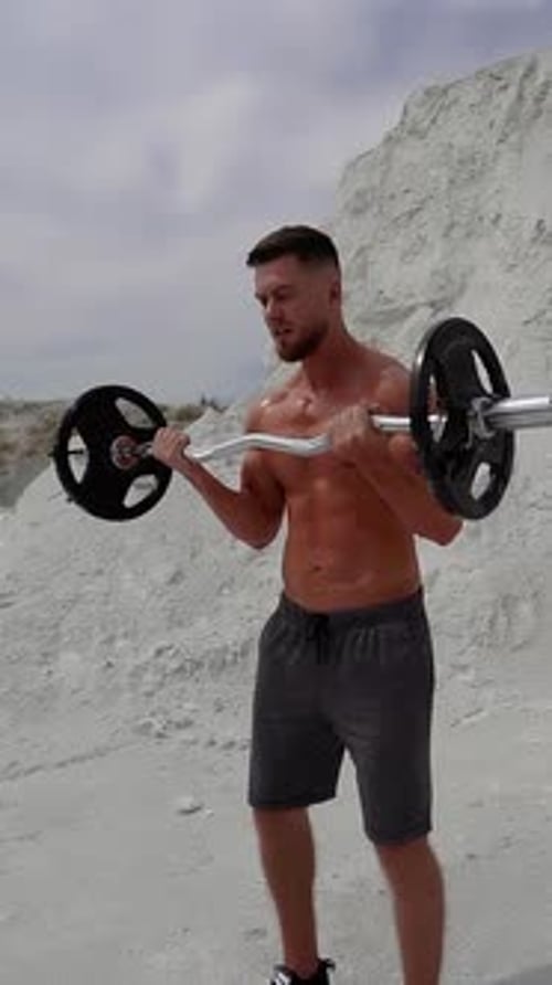 Muscular Man Lifting Barbell Outdoors for Fitness