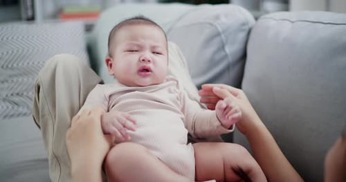 Crying Baby Being Comforted on Parent's Lap