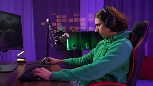 Male Gaming in Purple Lit Room Frustrated at Game