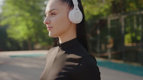 Woman Wearing Headphones Outdoors Before Workout