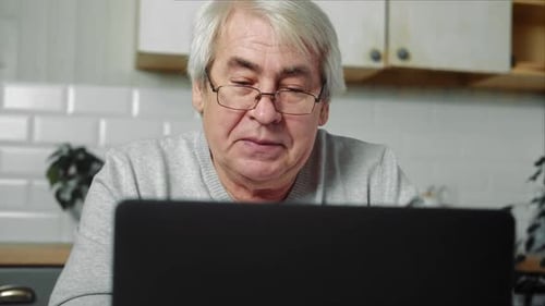 Mature Adult Using Computer At Home