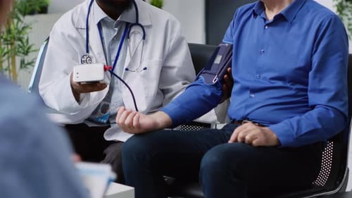 Doctor Checking Patient's Blood Pressure in Waiting Area