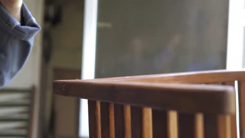 A Carpenter in His Workshop Assembles a Handmade Chair Screws a Bolt Secures It with a Hex Key