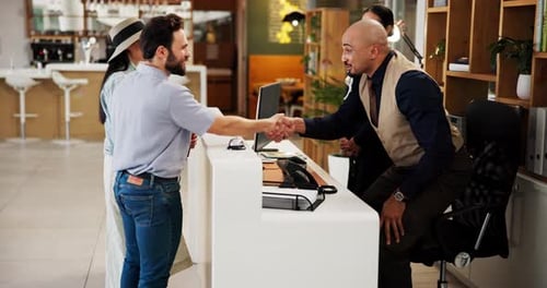 Hotel, people and receptionist with handshake for welcome, introduction and help for accommodation