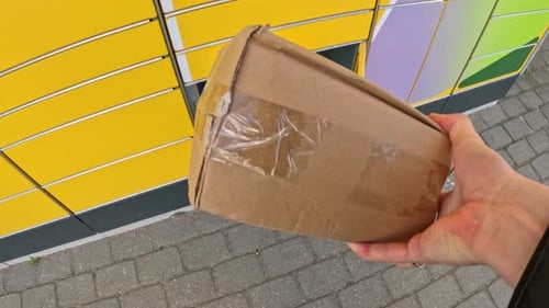 Pick up cardboard box from yellow post POV view