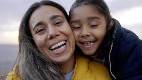 Smiling Woman and Child Posing Outdoors