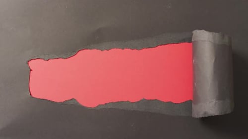 Torn Black Paper Revealing a Red Surface