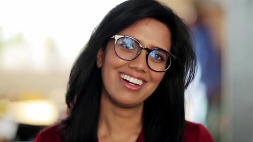 Smiling Woman with Glasses Looking at the Camera