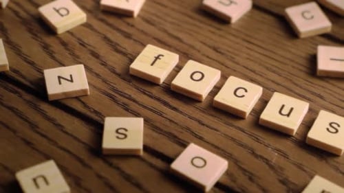 Letter Tiles Spelling Focus on Wooden Surface