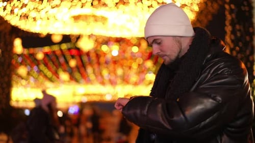 Sad Caucasian Man Checking Time Standing on the Right in Urban City at Night and Leaving