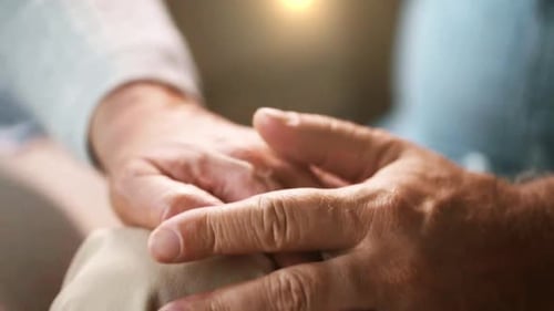 Loving Senior Couple Holding Hands Close Up