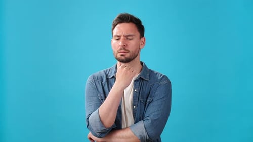 Worried Man Touches Chin Thinking About Solving Problem